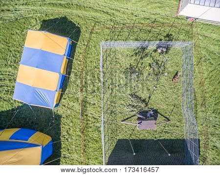 Aerial view of a circus tent with cage of white tigers