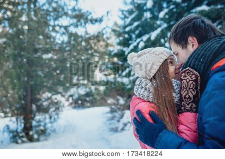 Man with a woman walking in the winter snow park