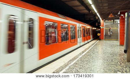 Hamburg, Germany - October, 10, 2016: Metro subway train arrives to station. People at subway metro underground tube station walk to get the arriving train. European public transportation system.
