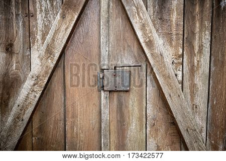 lock and door handle on weathered wooden door, Serbia