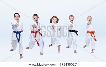 Five karateka children are beating punch arm