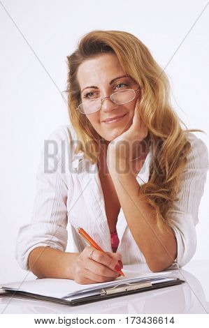 Businesswoman sitting in office and writing plan perfect day for superhuman productivity in his diary. (Time management success productivity work concept)