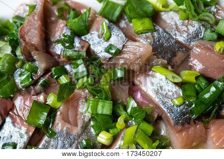 Sliced herring with onions on a cutting board