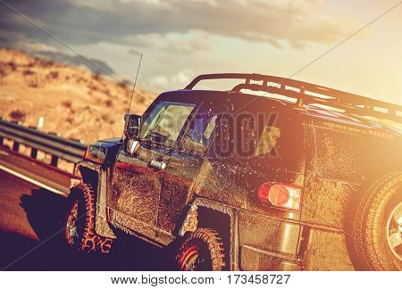 Dirty Off Road Trip. Dirty Full of Mud SUV Type Car Right After Crossing Wet Desert.