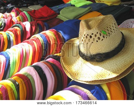 Hats and tuques being offered at a market