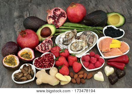 Large aphrodisiac food selection for good sexual health over marble background.
