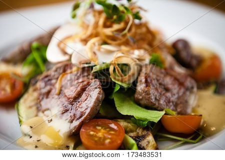 Brutus salad with beef tenderloin served on a plate