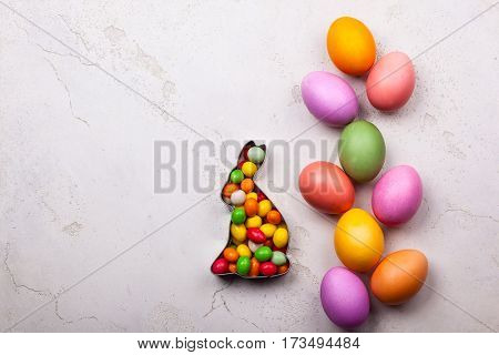 Easter concept with natural dyed easter eggs and candy. Flat lay