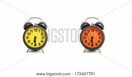 Closeup yellow alarm clock and orange alarm clock for decorate show a half past nine or 9:30 a.m. isolated on white background