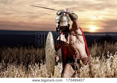 Sepia toned shot of a Roman legionary soldier fighting with his sword copyspace warzone combat attack weapon concept