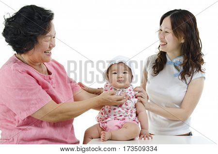 Portrait of happy multi generations Asian family, senior woman, adult daughter and baby girl, isolated on white background.