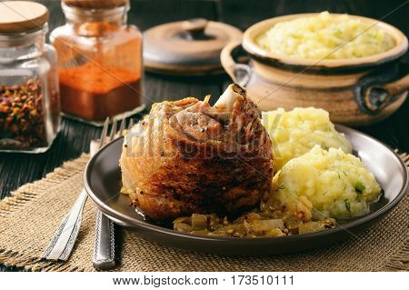 Baked turkey drumstick(knuckle) with onion and mustard sauce. Served with mashed potatoes.
