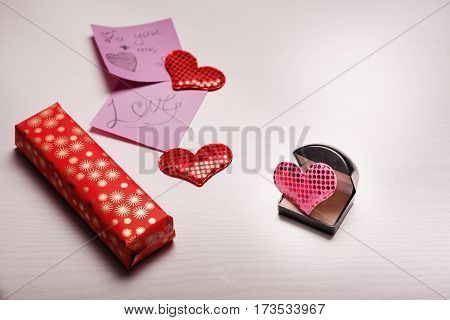 Wooden White Background With A Branch Of Pine And Three Hearts.