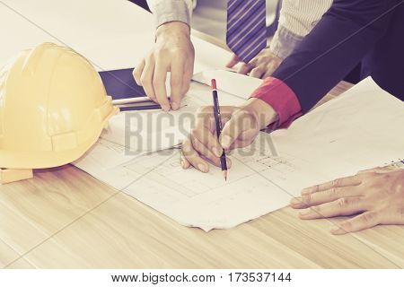 Meeting of the engineers design team working and discussion on construction project in cafe