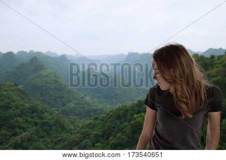 Young woman is looking down from the mountain top, Vietnam