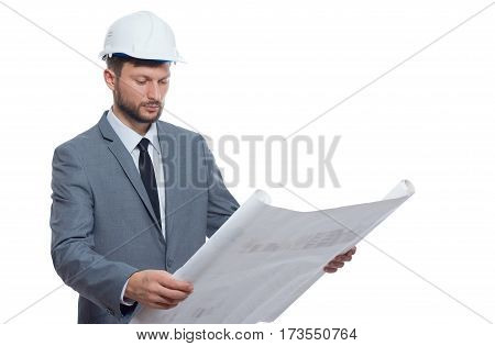 Diligent professional. Handsome mature bearded male architect wearing hardhat looking serious while examining blueprints isolated on white professionalism experience confidence project urban concept