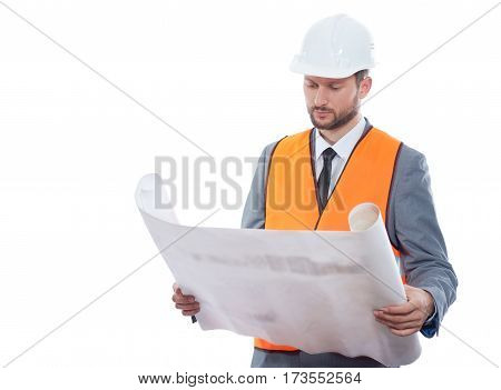 Construction creativity. Confident businessman engineer holding blueprints posing confidently on white background wearing protective helmet and safety vest copyspace profession businesspeople concept