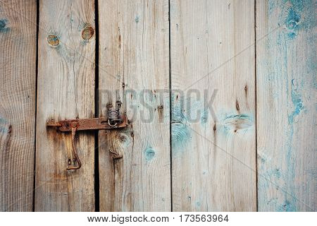 Old wooden door with rusty lock and old latch
