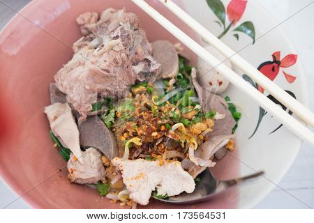 Thai Fusion Food dry noodle with pork in ceramic bowl with Thai style spice