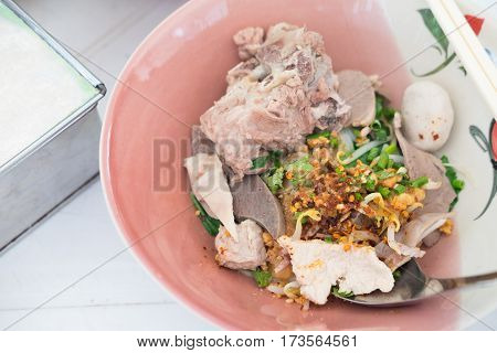 Thai Fusion Food dry noodle with pork in ceramic bowl with Thai style spice