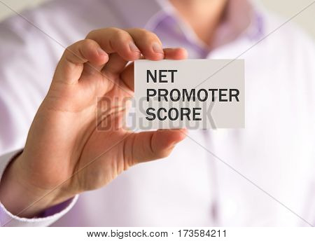 Businessman Holding A Card With Nps Net Promoter Score Message