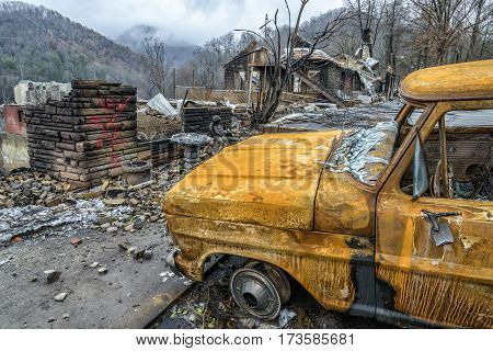 GATLINBURG TENNESSEE/USA - DECEMBER 14 2016: A cremated truck and a burned structure remain after a forest fire burned part of Gatlinburg in late 2016.
