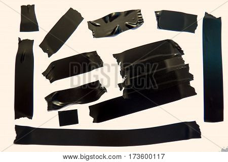 A collection of used black adhesive tape pieces