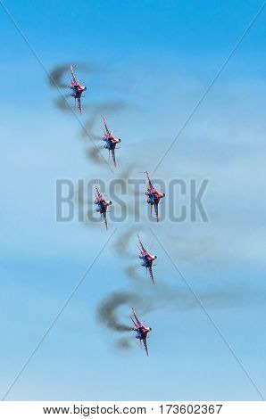 A group of six fighter aircraft in the blue sky with smoke. Russia. Moscow 28 August 2015