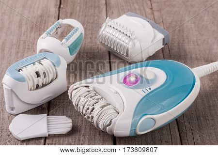 electric epilator on an old wooden background. Hair removal device