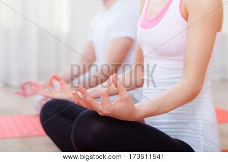 Young people relaxation do yoga indoors class