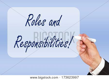 Roles and Responsibilities - hand writing text on blue background