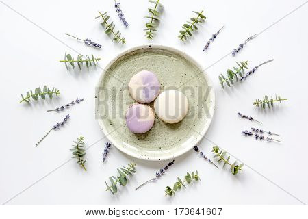 light woman breakfast with macaroons on spring pattern in pastel color white background top view