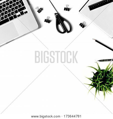Square crop. White office desk frame with laptop keyboard and supplies. Laptop, notebook, pen, clips, pencil, plant, scissors and office supplies on white background. Flat lay, top view, mockup