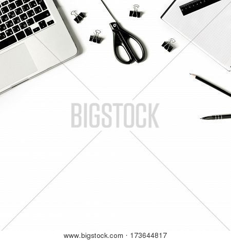 Square crop. White office desk frame with laptop keyboard and supplies. Laptop, notebook, pen, clips, pencil, scissors and office supplies on white background. Flat lay, top view, mockup
