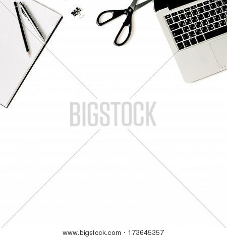 White office desk frame with laptop keyboard and supplies. Laptop, notebook, pen, clips, pencil and office supplies on white background. Flat lay, top view, mockup