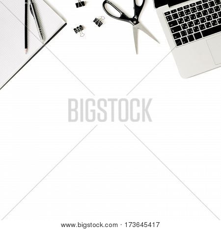 White office desk frame with laptop keyboard and supplies. Laptop, notebook, pen, clips, pencil and office supplies on white background. Flat lay, top view, mockup