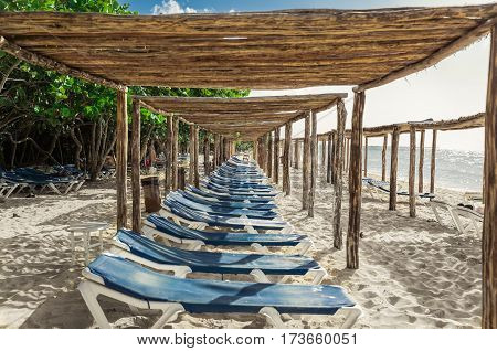 Cayo Coco island, Memories Caribe, Cuba, July 2, 2016, beautiful gorgeous inviting view of Cuban beach with sun sheds, sun beds and people relaxing in background at sunset  time