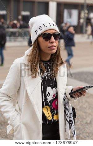 MILAN ITALY - FEBRUARY 23: Fashionable woman poses outside Genny fashion show during Milan Women's Fashion Week on FEBRUARY 23 2017 in Milan.