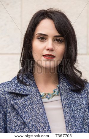 MILAN ITALY - FEBRUARY 23: Fashionable woman poses outside Genny fashion show during Milan Women's Fashion Week on FEBRUARY 23 2017 in Milan.