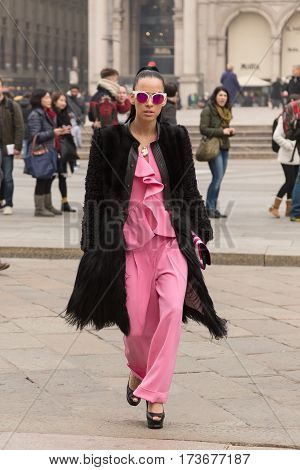 MILAN ITALY - FEBRUARY 23: Fashionable woman poses outside Genny fashion show during Milan Women's Fashion Week on FEBRUARY 23 2017 in Milan.