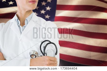 Mid section of a female doctor with stethoscope in hospital against composite image of digitally generated united states national flag