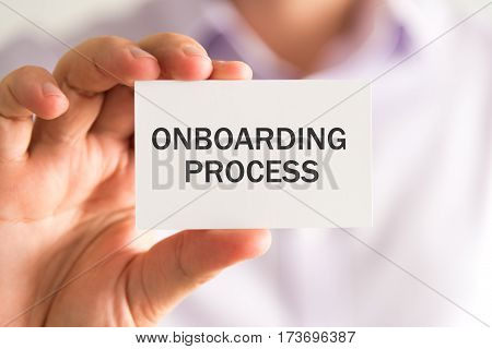 Businessman Holding A Card With Onboarding Process Message