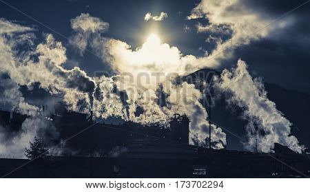 Smoking chimneys and shinning sun in factory Mondi Ruzomberok - Slovakia. Air pollution