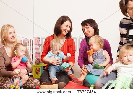 Group of mothers with their children gathered to talk
