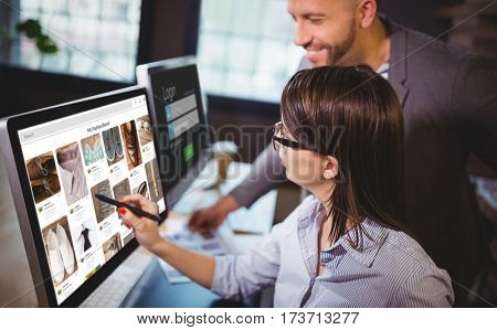 Composite image of website page against female photo editor discussing over computer with male colleague