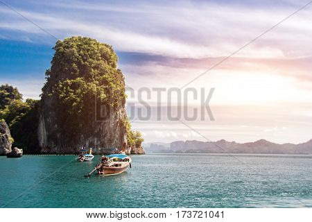 fisherman wood boat on green ocean Thailand