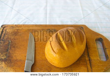 head of traditional Adygei cheese handmade with knife on wooden Board