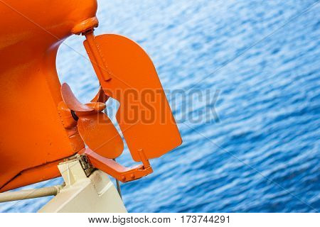 Propeller of boat motor on a background of blue sea.