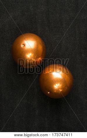 pair of copper Chinese singing balls Baoding of health for hands on black background