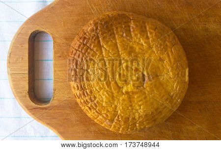 head of traditional Adygei cheese handmade on wooden Board